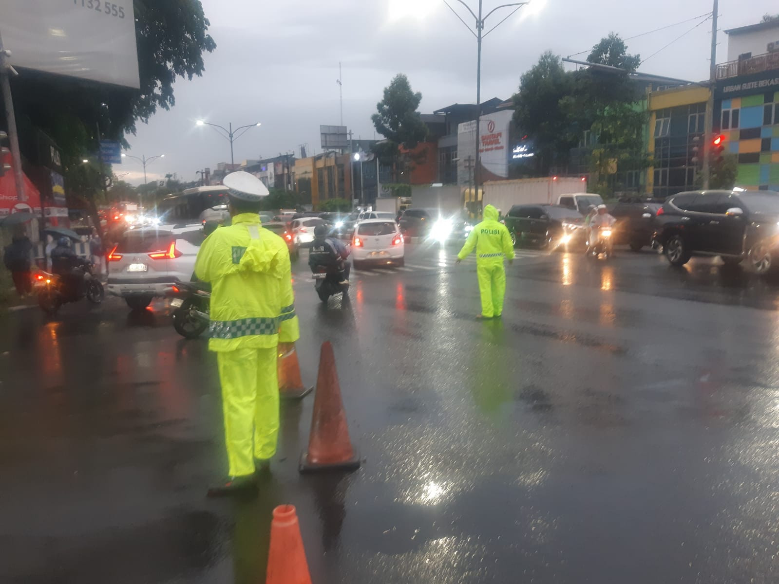 Personel Lantas Polsek Rawalumbu Lakukan Penguraian Kemacetan Akibat Hujan Deras
